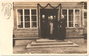 Vyskupas Staugaitis su prelatu Jonu Mačiuliu-Maironiu (?), kanauninku Juozu Valaičiu ir kitais kunigais prie Rietavo klebonijos durų apie 1930 m.