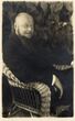 Eugenijaus Šalkausko, sėdinčio pintame krėsle, portretas